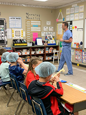 Dr Clayton with local students